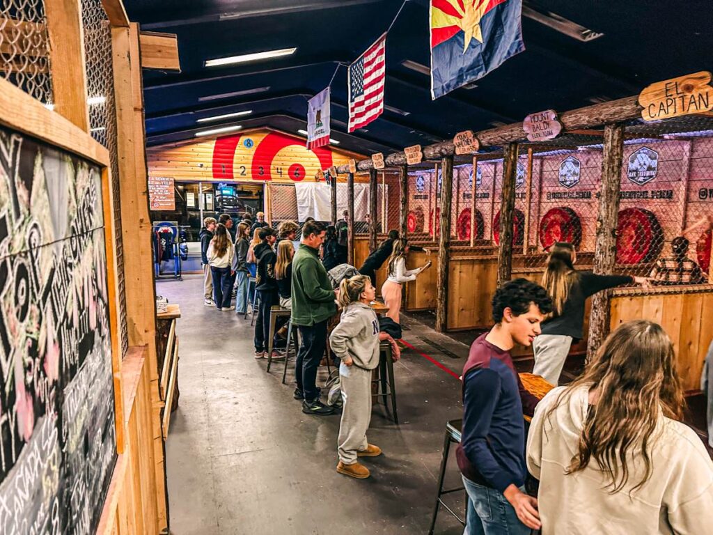 A large group of people enjoy ace throwing at a bar in Big Bear California